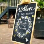 bruiloft-welkomstbord. Leandra en Hendri, versierd door Hilde van Milligen, geïnspireerd op de trouwkaart.
